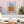 Foglie color cuoio - Opera che rappresenta una casa e fiori con un collage che offre una narrazione visiva ricca e stratificata.